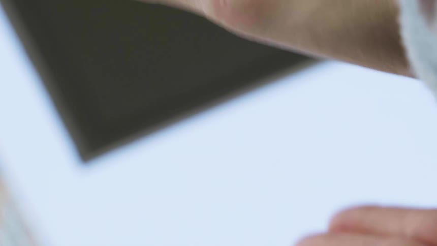A persons hand clapping with the sky above
