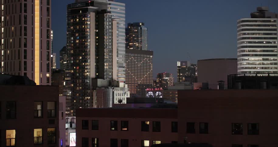 The windows on the building are lit in the shape of a heart