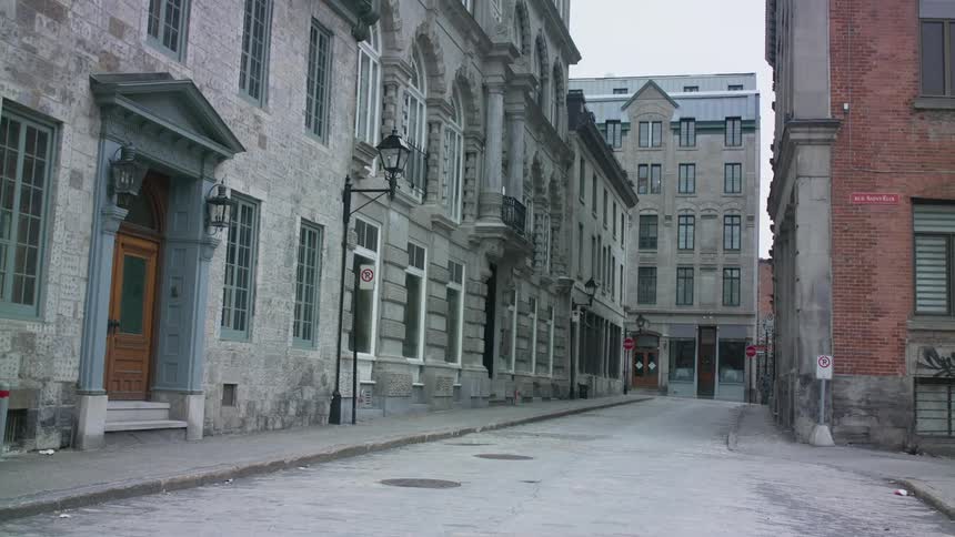 Stone and brick buildings line a city street