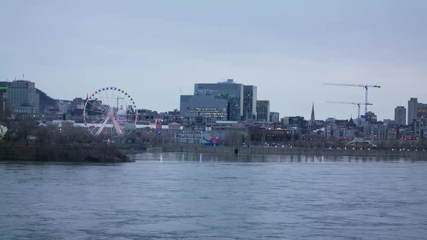 The ocean waves are moving towards the coast of a downtown city