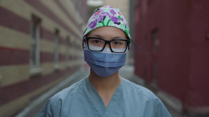 A doctor wears a face mask in the alley