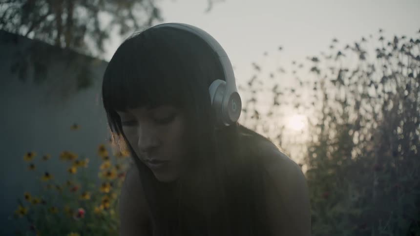 Close up of a woman outside wearing headphones