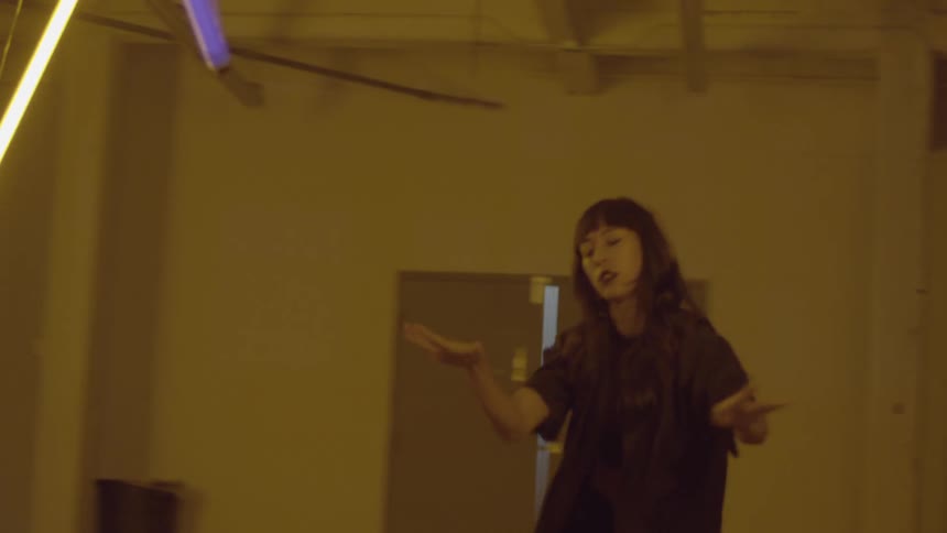 A woman is dancing in a large room