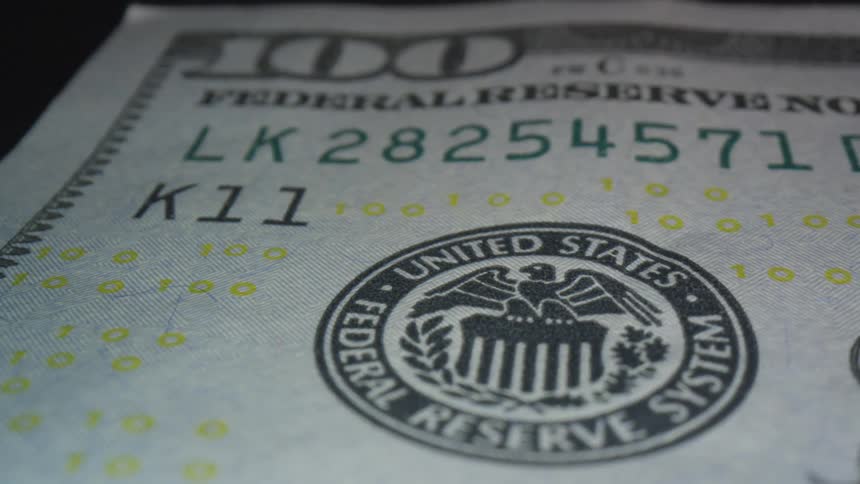 A hundred dollar bill spins in place