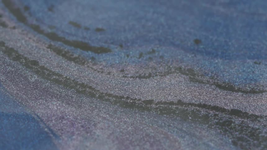 Different colored powders spread out on a flat surface