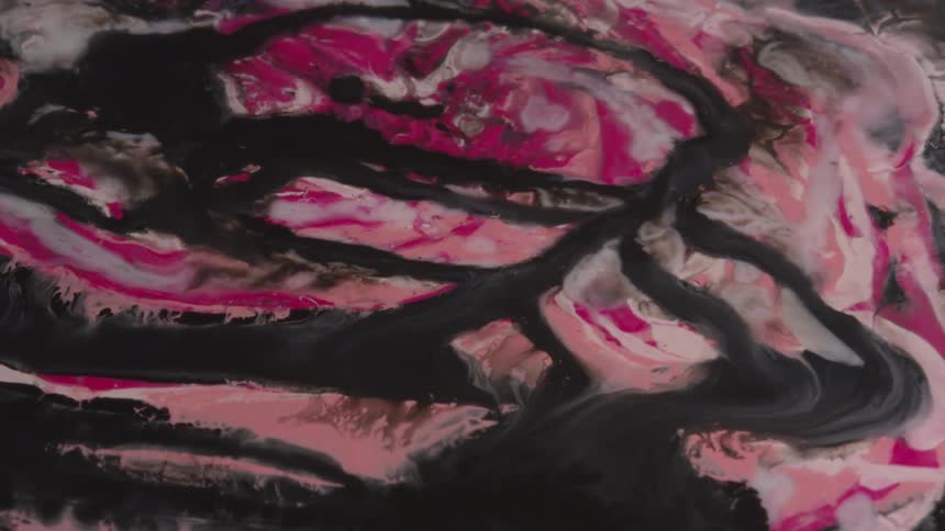 Black white and pink colors that look like water and sand