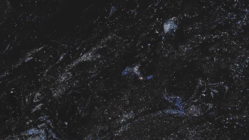 Flowing black fluid and glitter