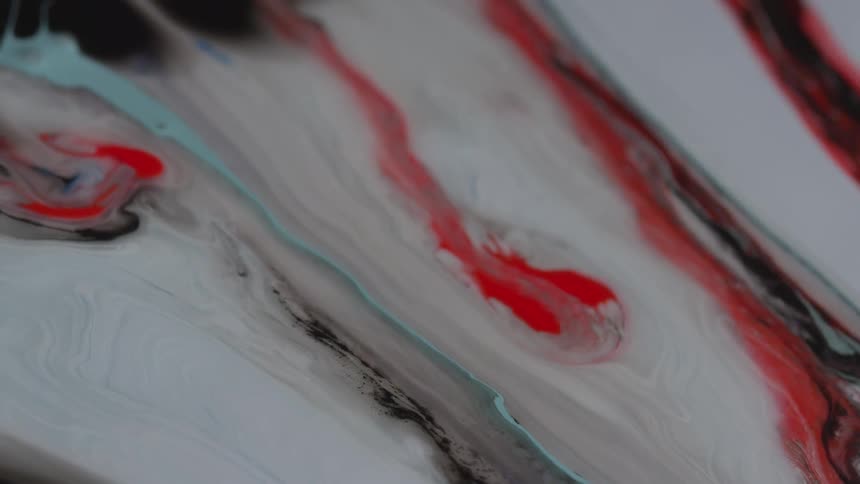 Red liquid flows into black and grey liquid