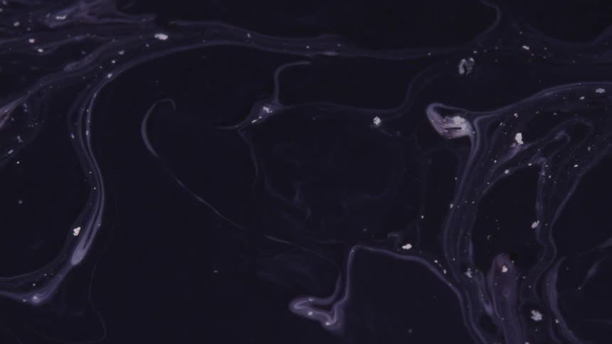 Black and white liquid ink swirling in flowing patterns