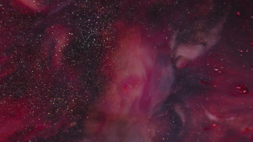 Abstract colorful red paint ink with glitter liquid diffusion psychedelic with movement
