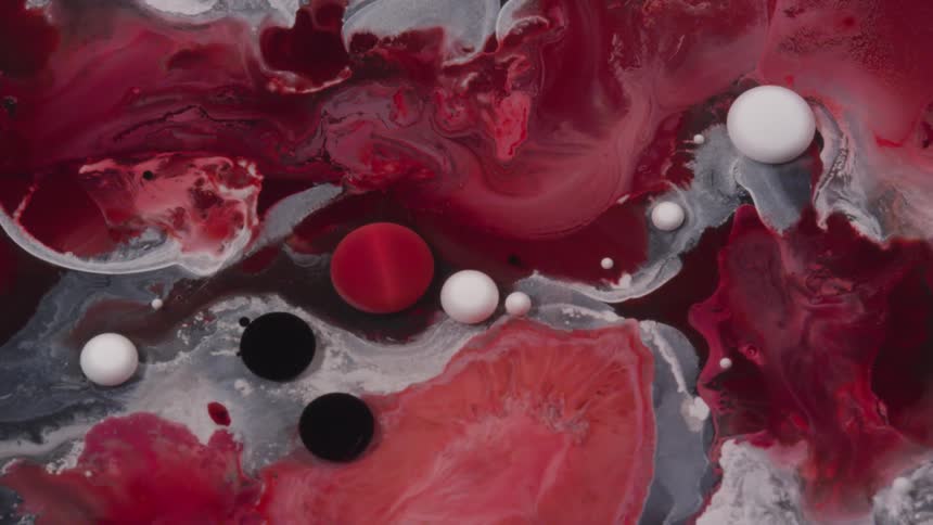 A red liquid flows in a red and gray liquid