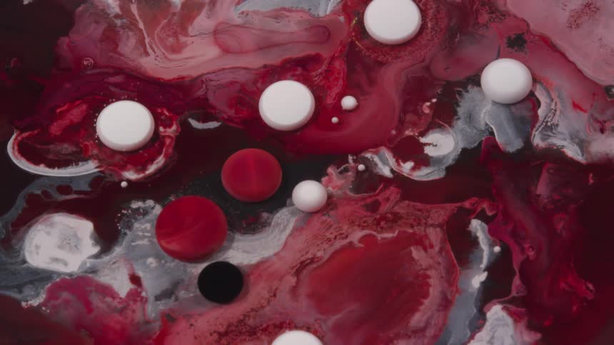 Droplets of red and white paint