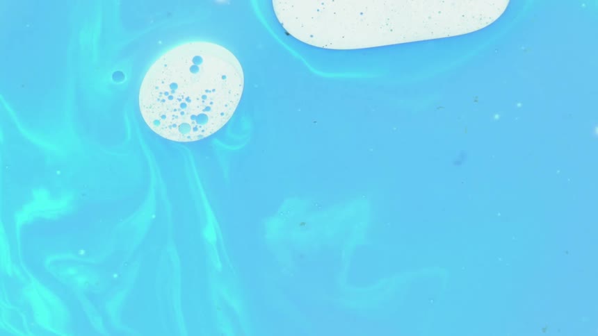 Abstract colorful blue teal paint ink liquid diffusion psychedelic with movement