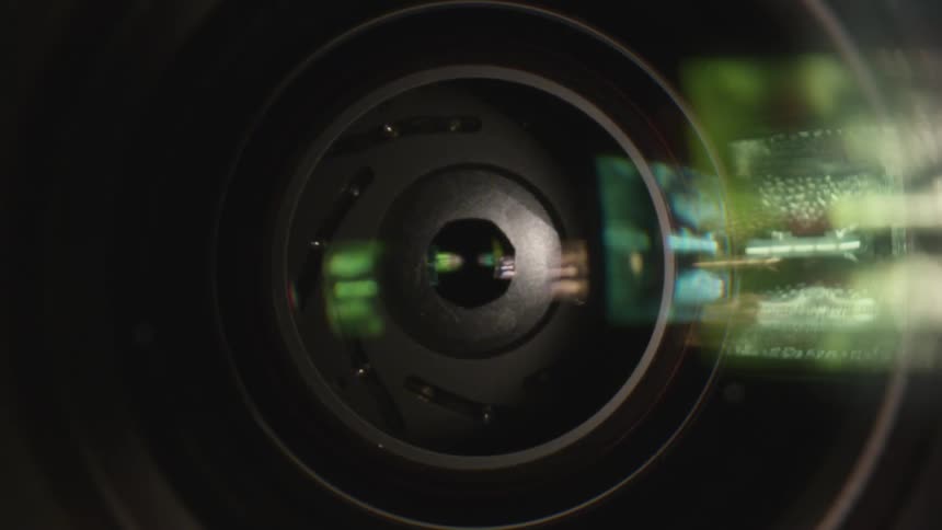 Extreme close up of a camera diaphragm opening and closing at high speed