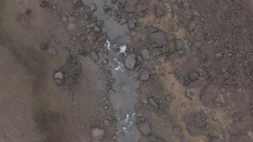River running through rocky barren landscape