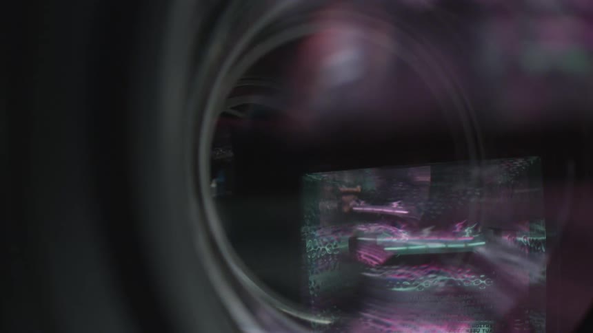 Black gray purple and green colors that look like a camera lens shuttering