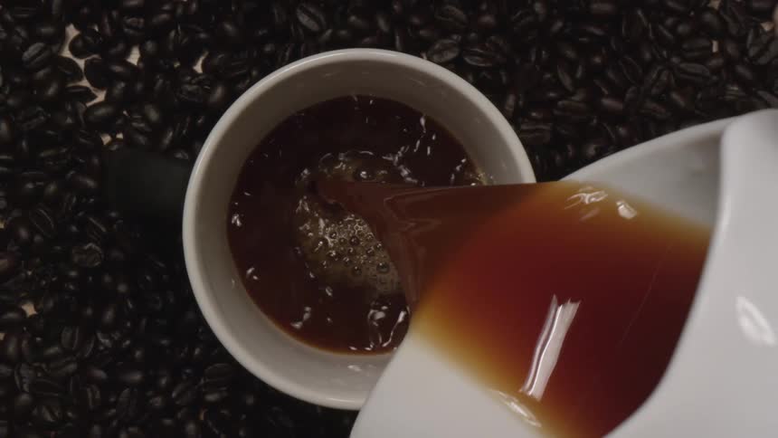 A person is pouring coffee into a cup