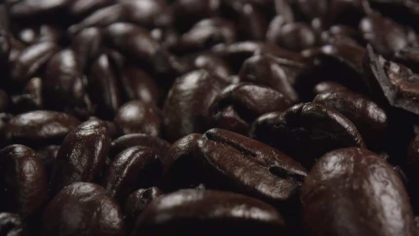 Close up of roasted shiny brown coffee beans