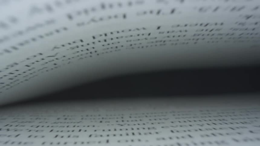 Type written pages close together against black background