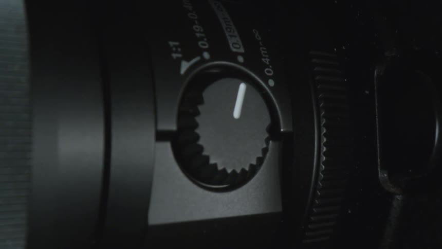 A camera with a dial and a lens