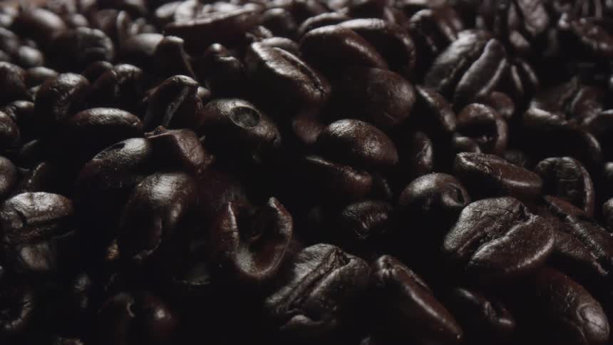 Close up mound of dark roasted coffee beans