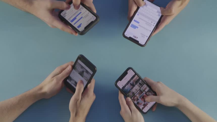 Four people use phones at the same time