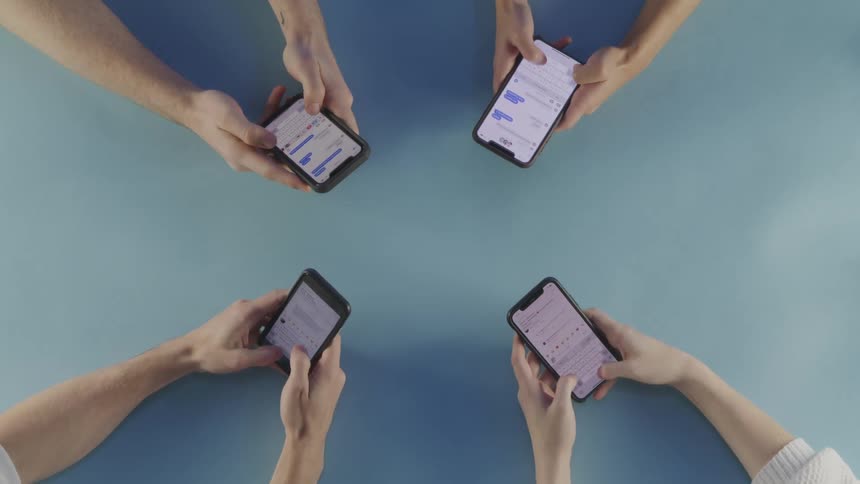 A group of people are texting on smart phones