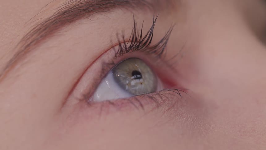 A woman slowly blinks her eye