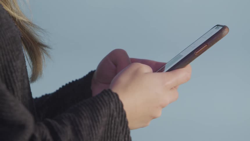 A woman is texting on a cellphone