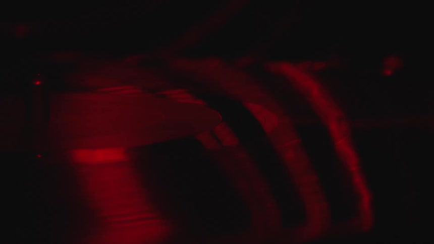Red lights form lines that are projected onto a black surface