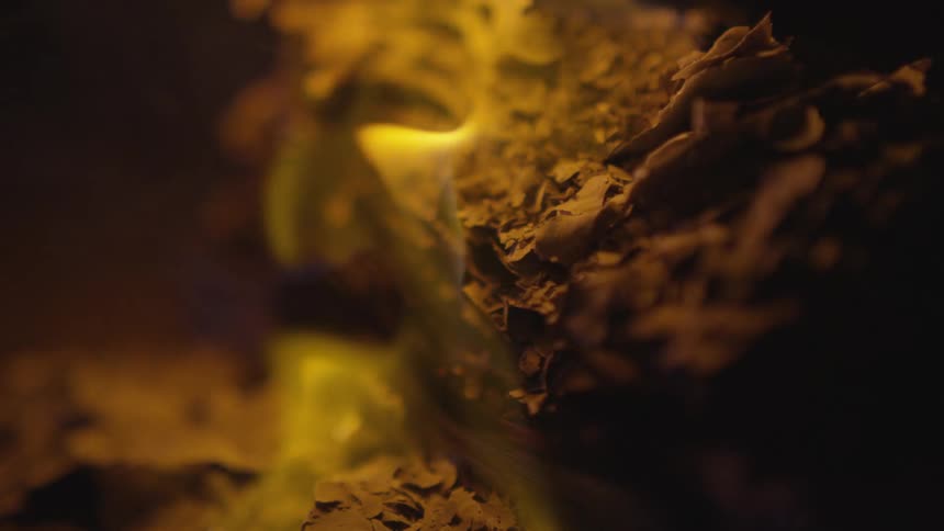 A fire is burning outdoors at night