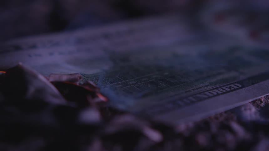 Smoke floating away from burning cash