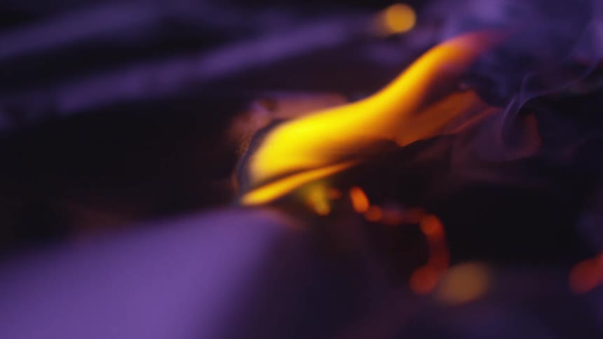 Close up of a piece of paper slowly burning