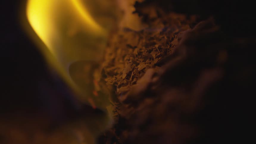 An object is burning outdoors at night