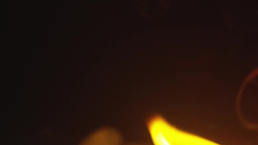 Close up of the flames and smoke of a fire at night