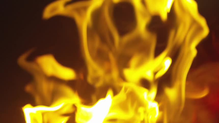 A close view of flames and smoke at night