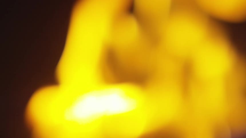 Out of focus flames on a campfire at night