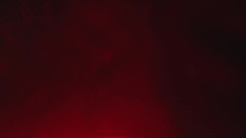 Red light reflecting on smoke in a dark room