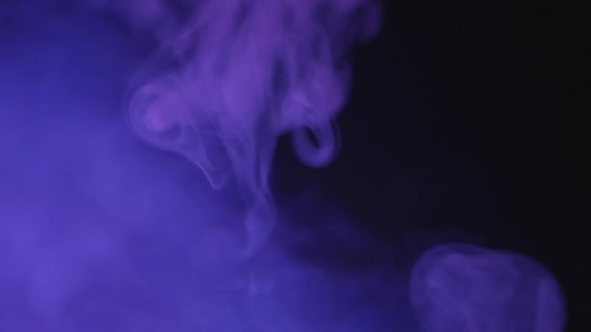 Billowing purple smoke in the dark