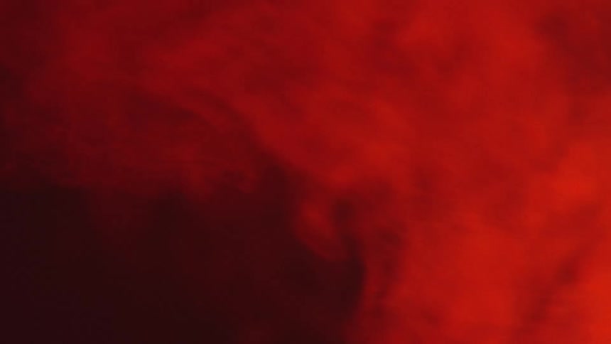 Red smoke billowing in the dark