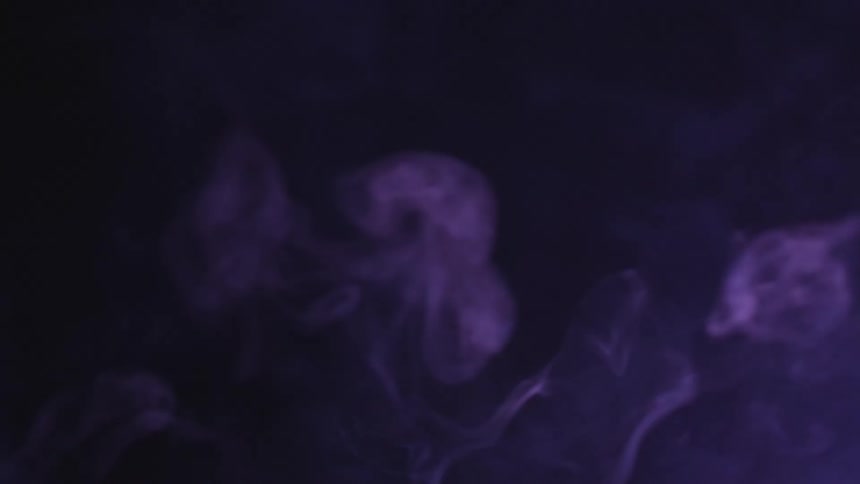 Swirling purple smoke in the dark