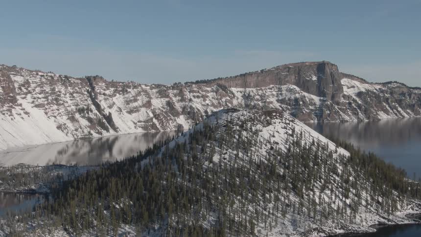 Aerial view of a snow covered mountain on the shore
