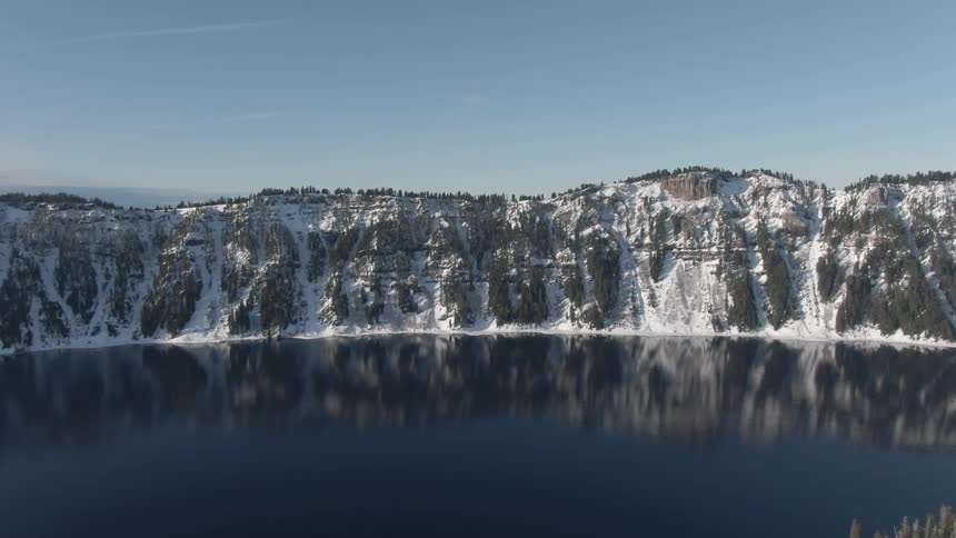 An aerial view of a mountain is displayed in midday