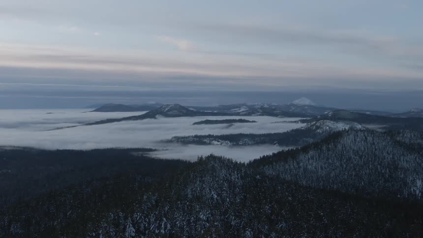 An aerial view of a mountain is displayed