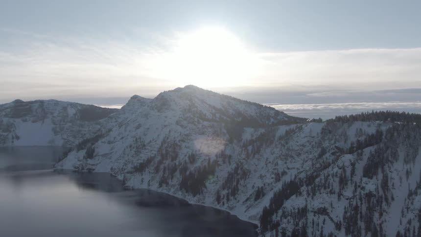 An aerial view of a snow covered mountain is displayed