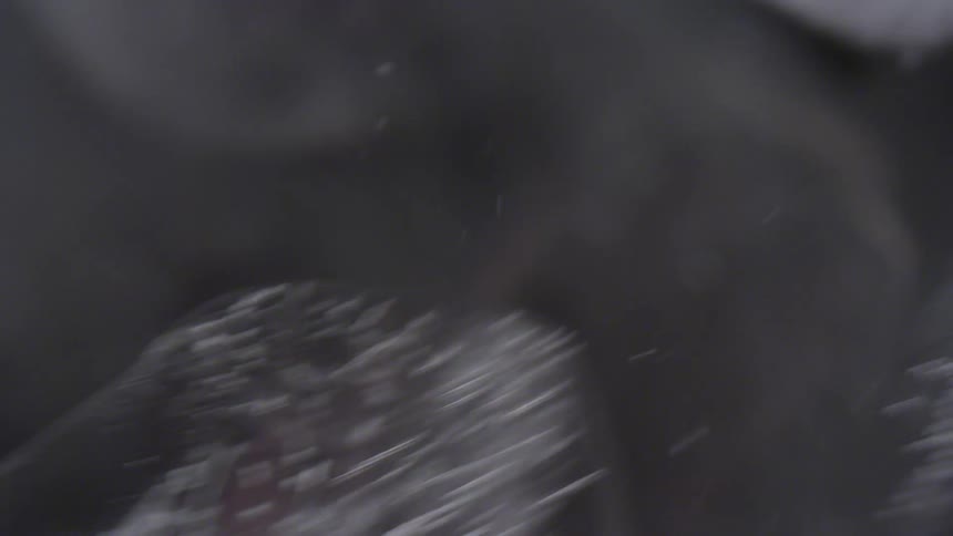 Ice cubes swirl through clear liquid