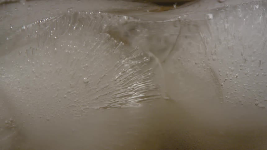 Droplets of water rise from the melting ice