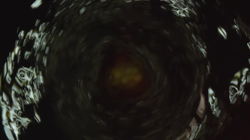 Top down close up of coffee swirling in a container
