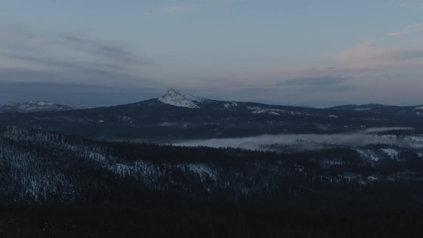 An aerial view of a mountain is displayed