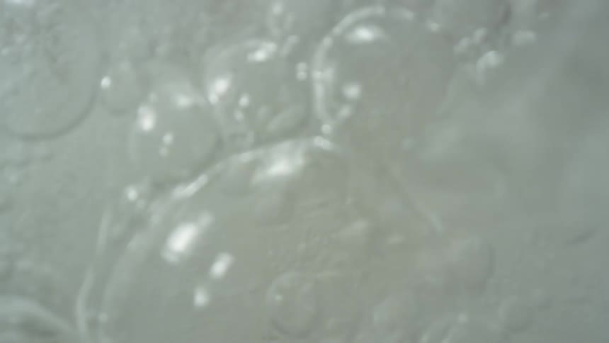 Water bubbling and being poured over ice